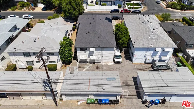 an aerial view of a house with a yard and potted plants