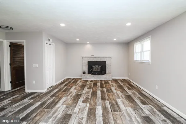 a view of empty room with window and fireplace