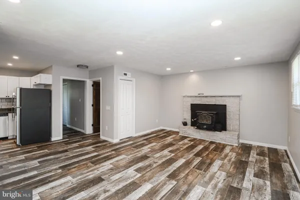 a view of empty room with a fireplace