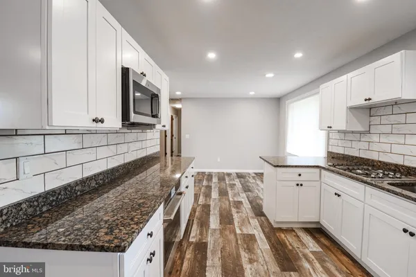 a kitchen with sink cabinets and stove