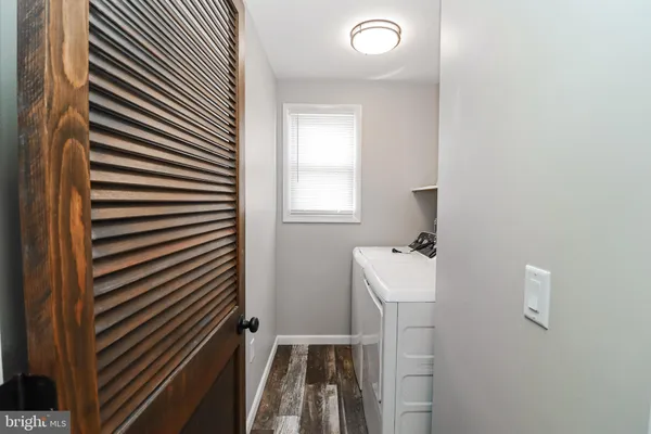 a bathroom with a sink toilet and a mirror