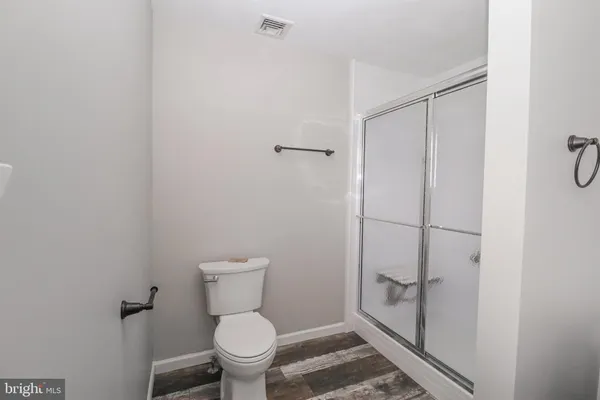 a bathroom with a toilet and a shower