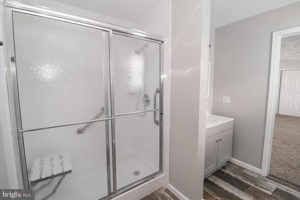 a bathroom with a glass shower door