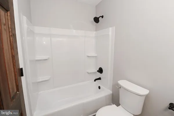 a bathroom with a toilet and a bathtub