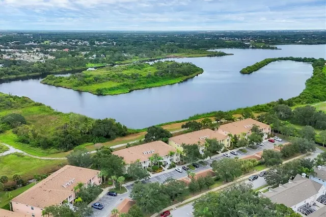 an aerial view of residential houses with outdoor space and river