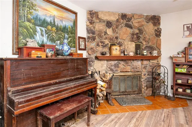 a living room with a fireplace and a floor to ceiling window