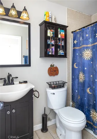 a bathroom with a toilet a sink and a mirror