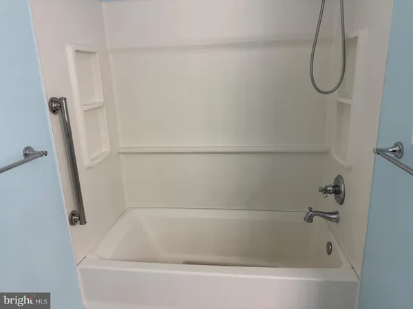 a kitchen with white cabinets sink and stove