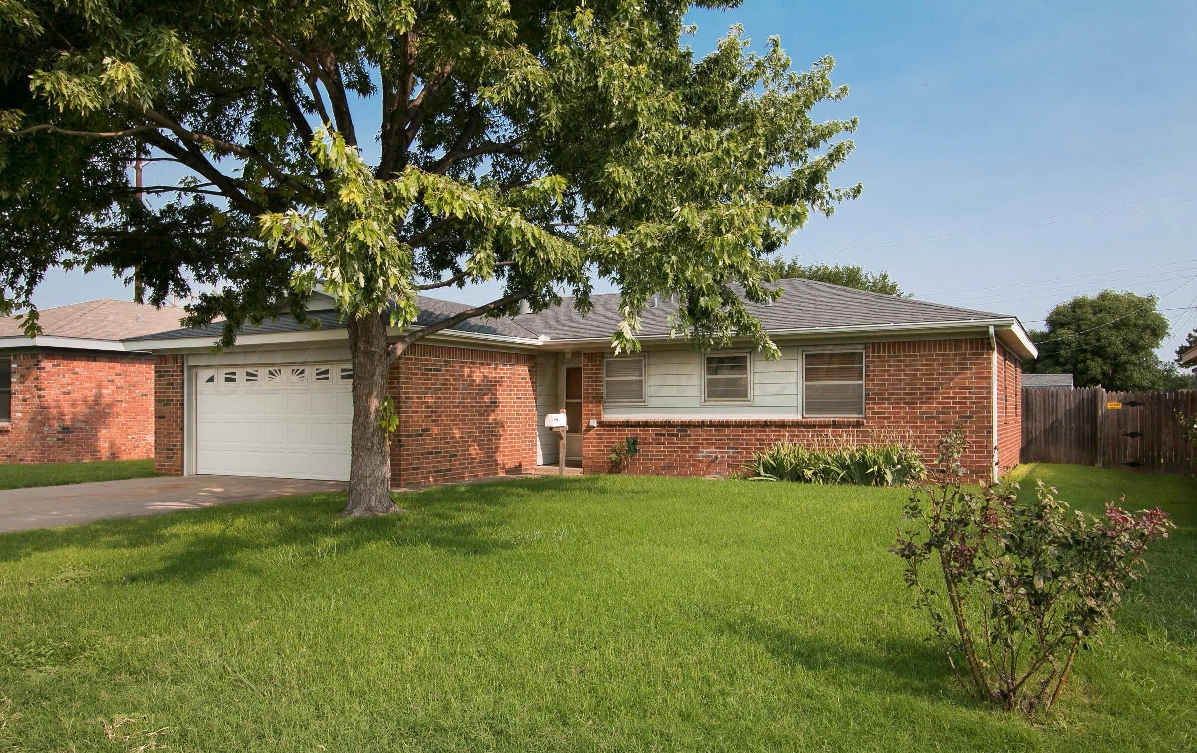 2414 Southwest 49th Avenue Amarillo, TX 79110 - Photo 1 of 28 a front view of a house with a garden and yard