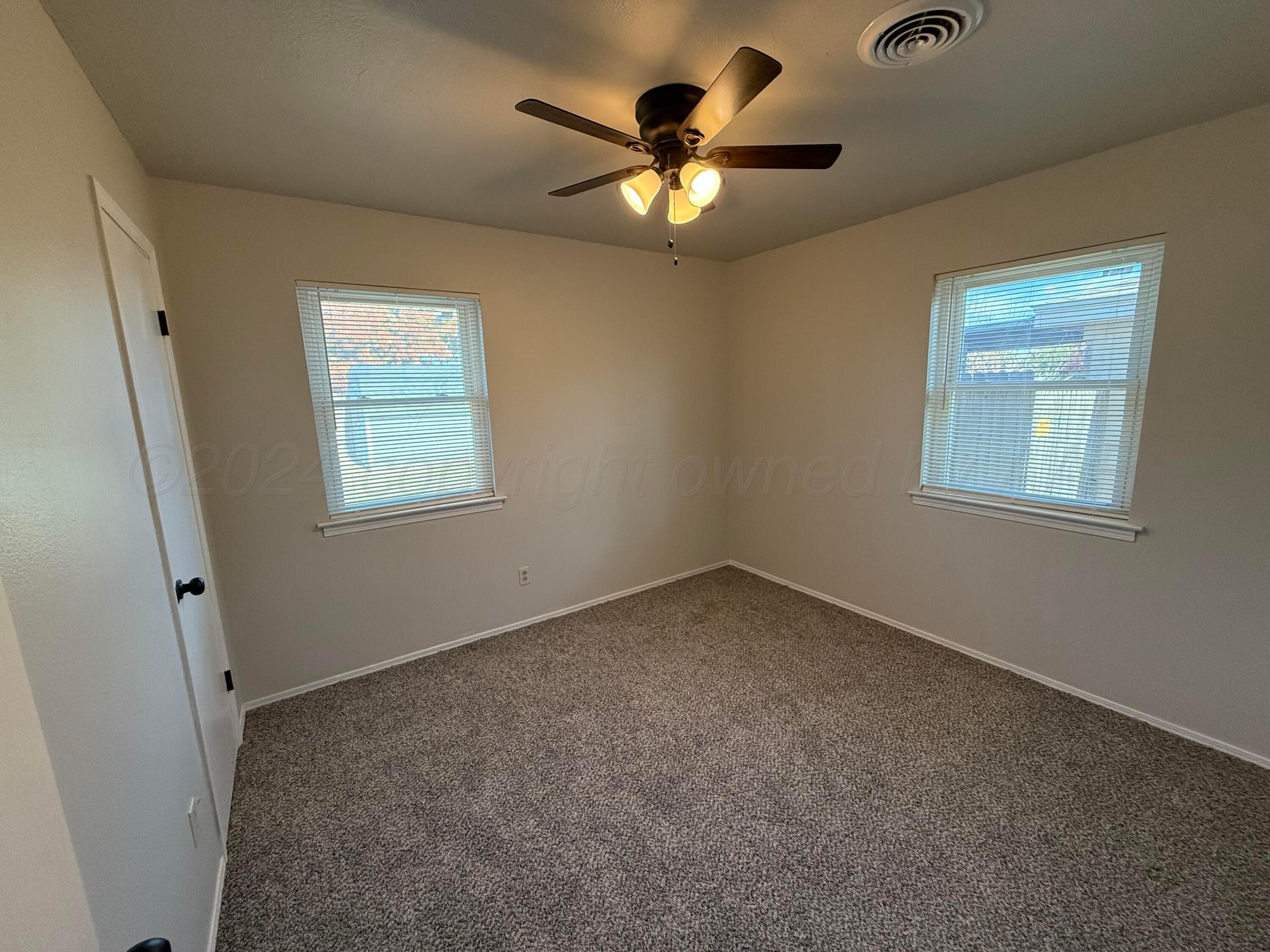 2414 Southwest 49th Avenue Amarillo, TX 79110 - Photo 16 of 28 an empty room with a window and a fan