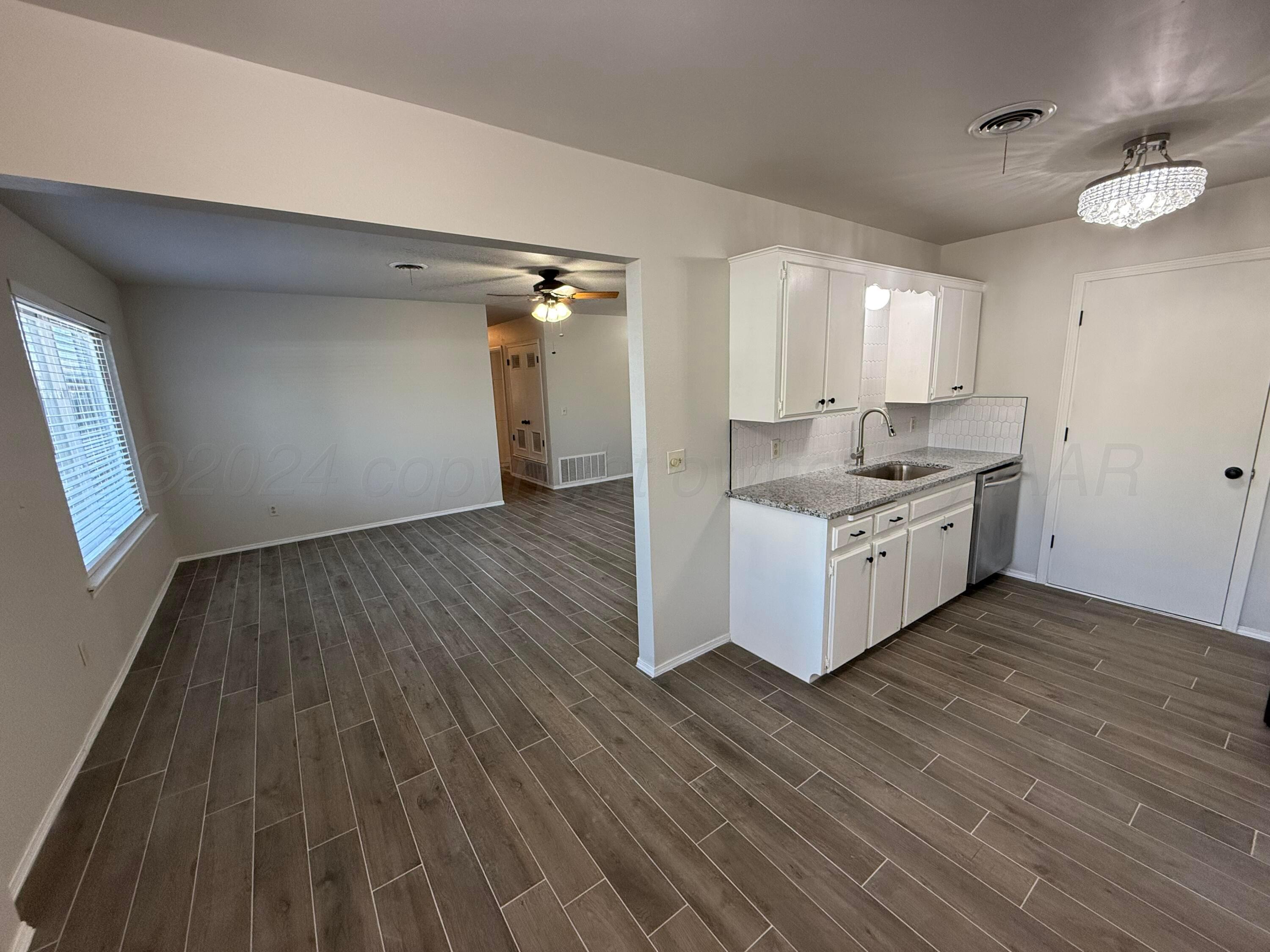 2414 Southwest 49th Avenue Amarillo, TX 79110 - Photo 7 of 28 a living room with a couch and wooden floor