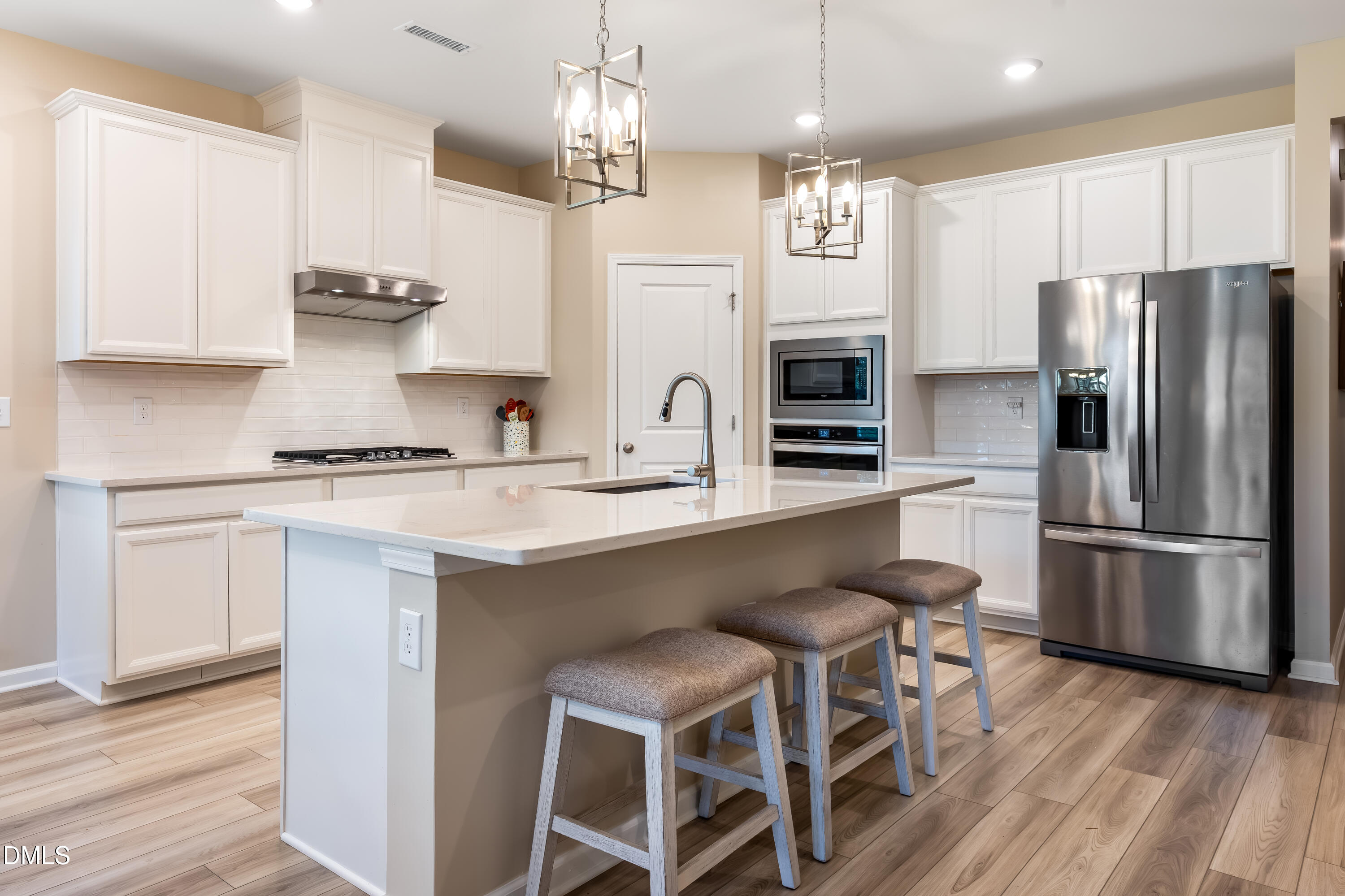 8017 Toddwick Court Raleigh, NC 27616 - Photo 4 of 30 a kitchen with stainless steel appliances a kitchen island hardwood floor and a sink