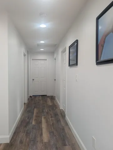 a view of hallway with wooden floor