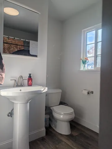 a white toilet sitting next to a bathroom sink