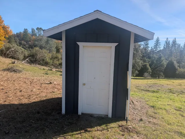 a view of a wooden door and a yard