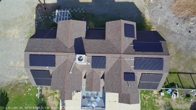an aerial view of a house with a yard and garage
