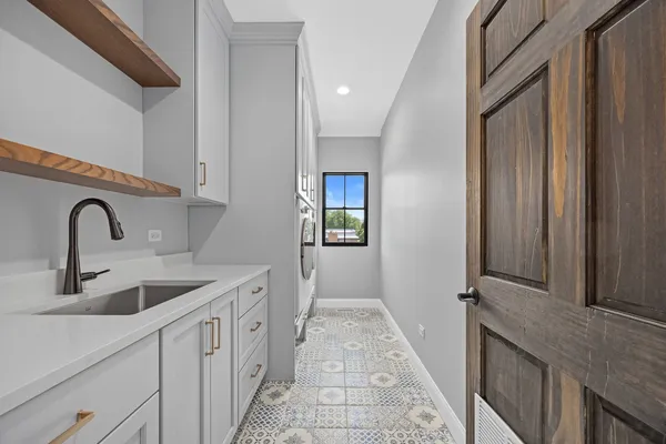 a kitchen with a sink and a wooden floor