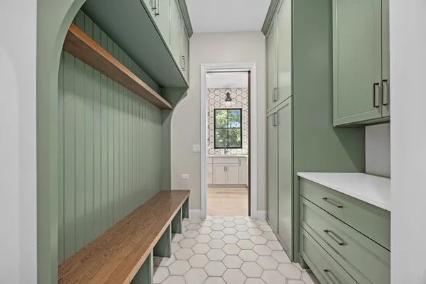 a view of hallway with cabinets and wooden floor