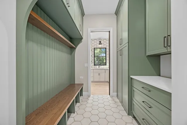 a view of hallway with cabinets and wooden floor