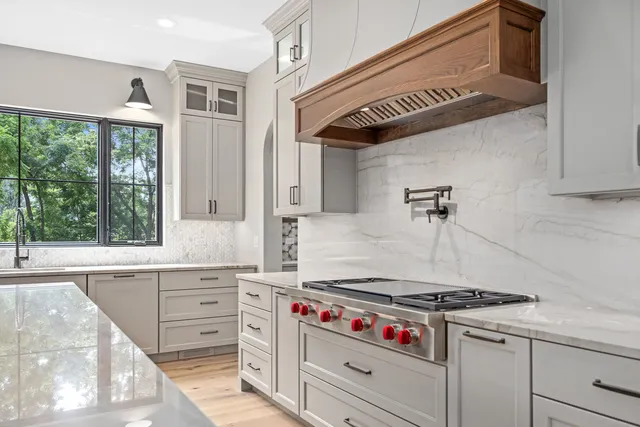 a kitchen with granite countertop a stove and a sink