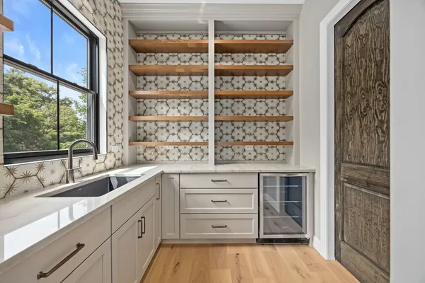 a kitchen with a refrigerator and window