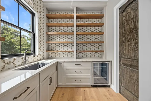 a kitchen with a refrigerator and window