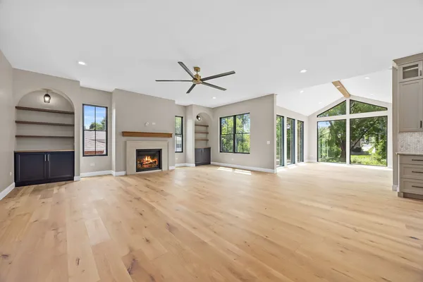 a view of an empty room with a fireplace and a window
