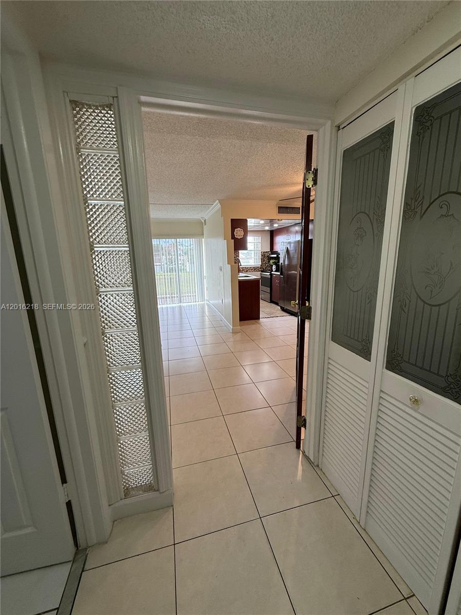 9321 Southwest 4th Street, Unit 230C Miami, FL 33174 - Photo 10 of 37 a view of a hallway and a livingroom with furniture