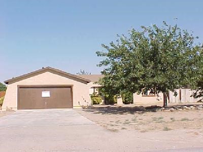 15965 Winnebago Road Apple Valley, CA 92307 - Photo 1 of 1 a front view of a house with a yard and garage