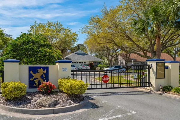 a living room with couches and a dining table with wooden floor