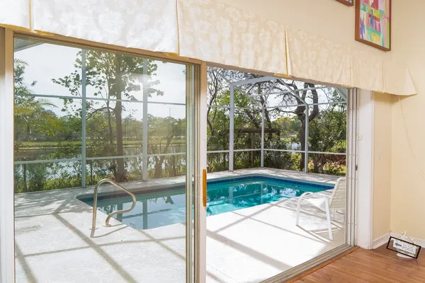 an aerial view of residential houses with outdoor space and ocean view