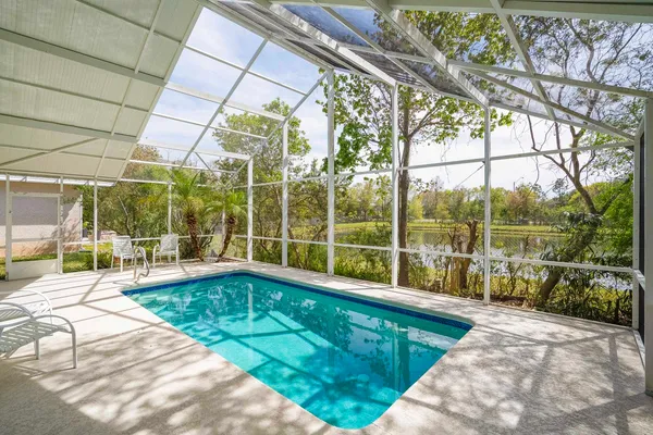 an aerial view of a house with a swimming pool yard and outdoor seating
