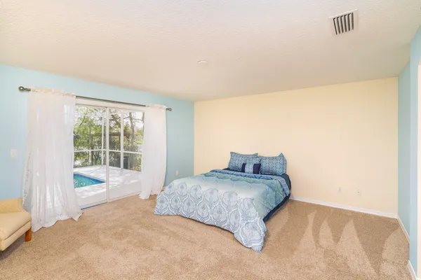 a view of a house with swimming pool and sitting area