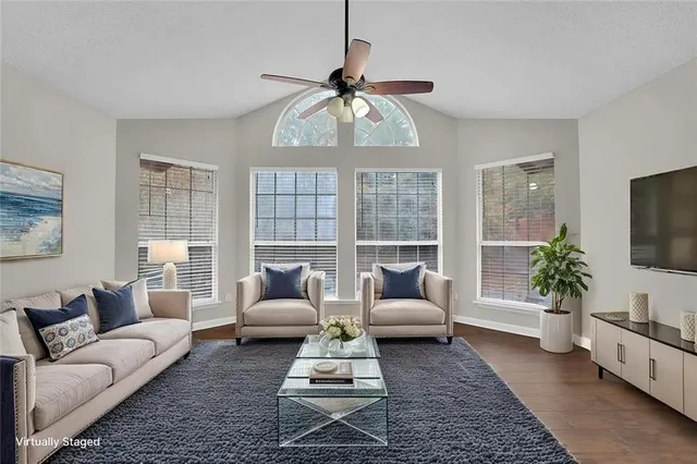 a living room with furniture and a large window