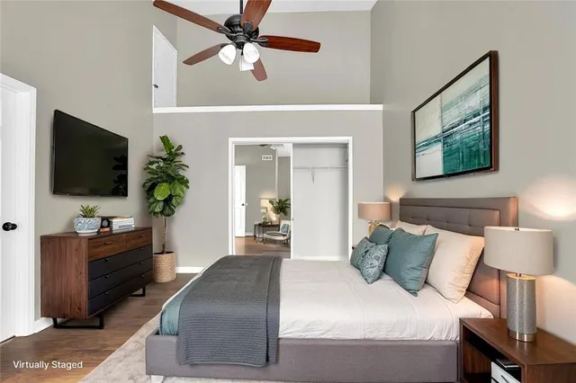a bedroom with a bed window and flat screen tv