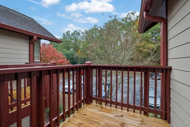 a balcony with wooden floor and outdoor space