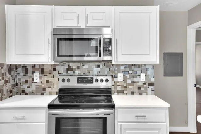 a stove top oven sitting inside of a kitchen