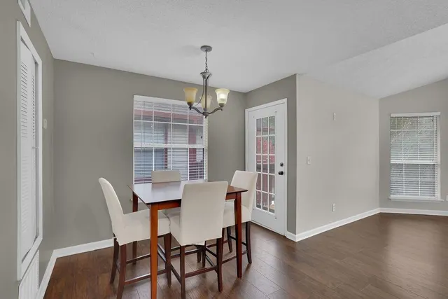 a view of a dining room with furniture wooden floor and chandelier