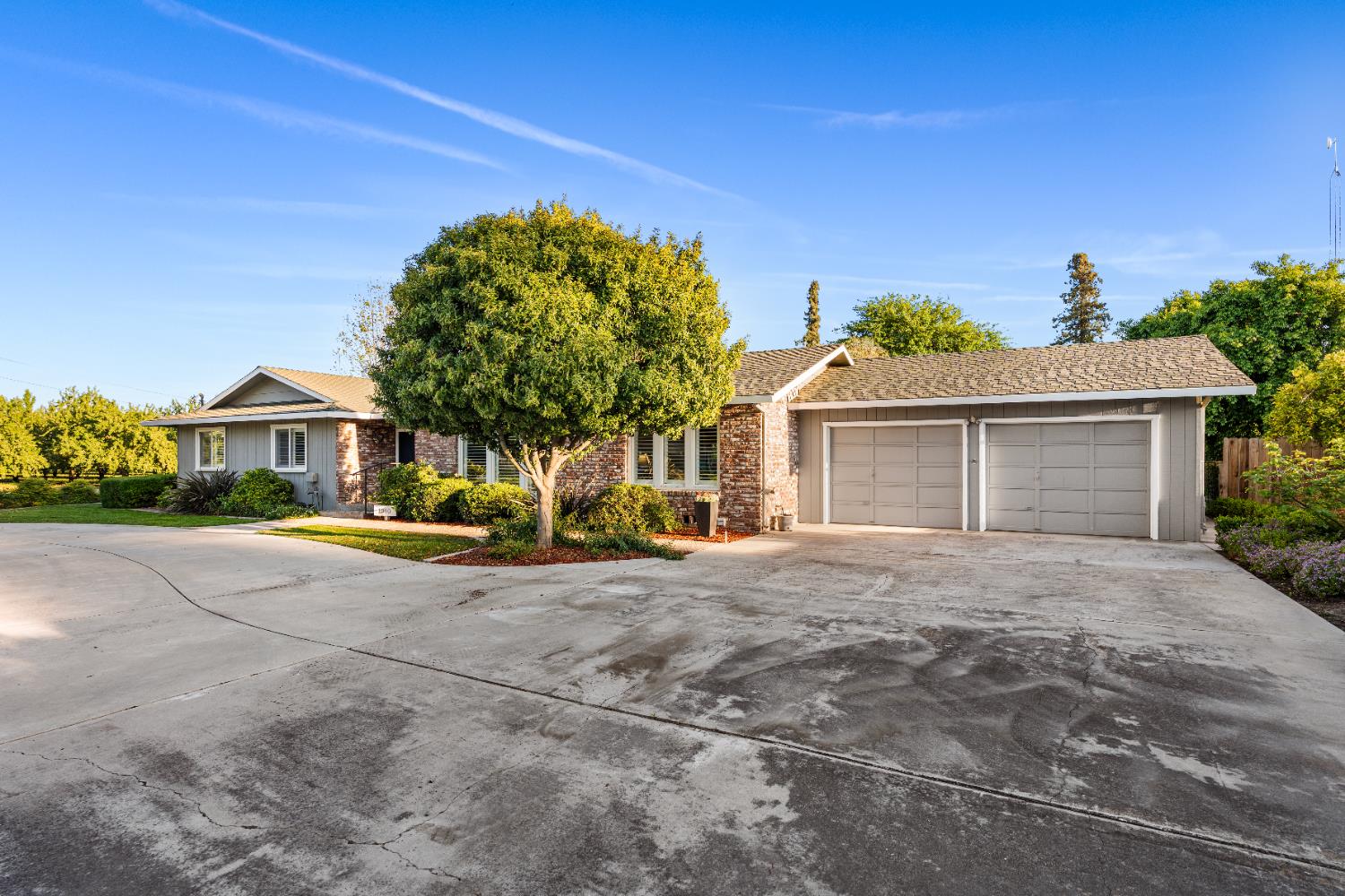 1360 Crawford Road Modesto, CA 95357 - Photo 1 of 1 a front view of a house with a yard and garage