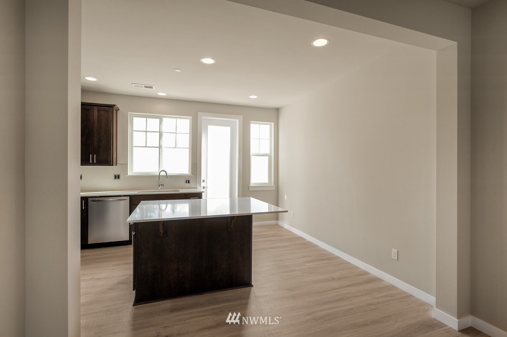 1621 Seattle Hill Road, Unit CC3 Bothell, WA 98012 - Photo 3 of 25 a view of an empty room with a window and wooden floor