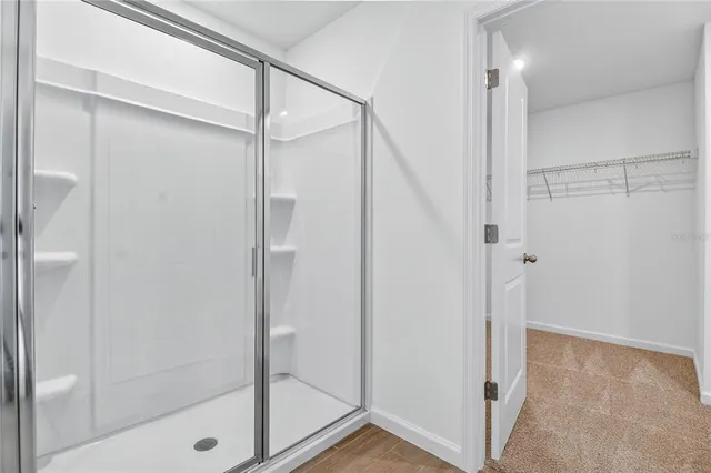 a bathroom with a glass shower door