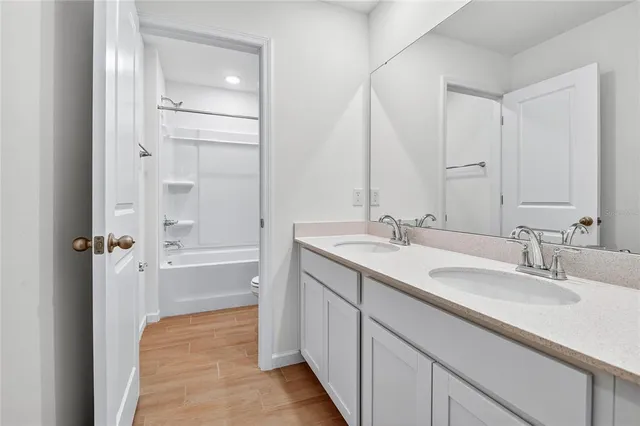 a bathroom with a double vanity sink mirror and