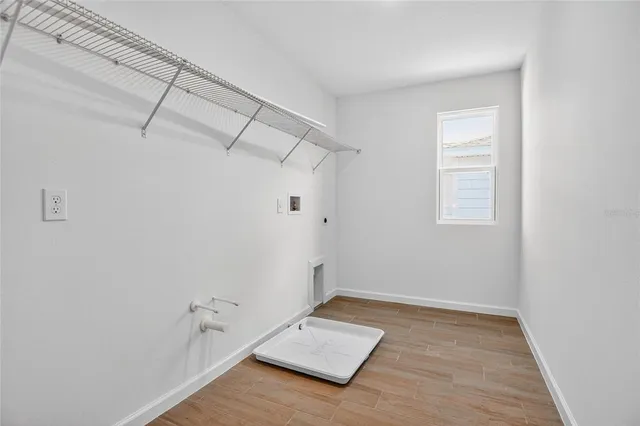 a view of a room with wooden floor and windows