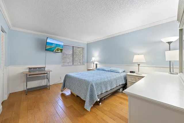 a bedroom with a bed and a desk with chair