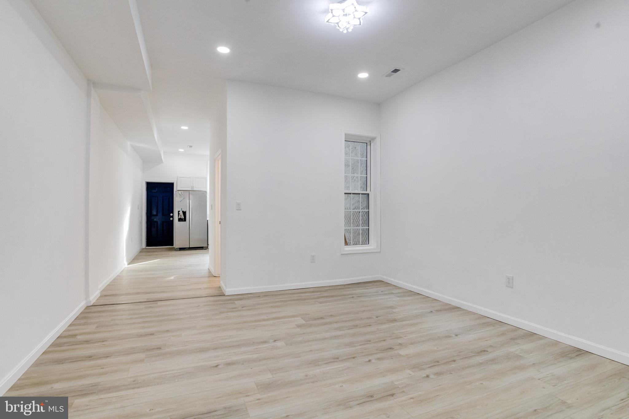 3015 Windsor Avenue Baltimore, MD 21216 - Photo 19 of 84 an empty room with wooden floor and windows
