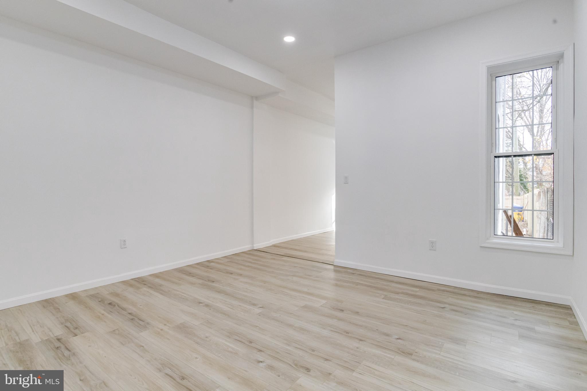 3015 Windsor Avenue Baltimore, MD 21216 - Photo 23 of 84 wooden floor in an empty room with a window