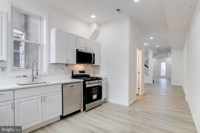 a kitchen with a sink and a window