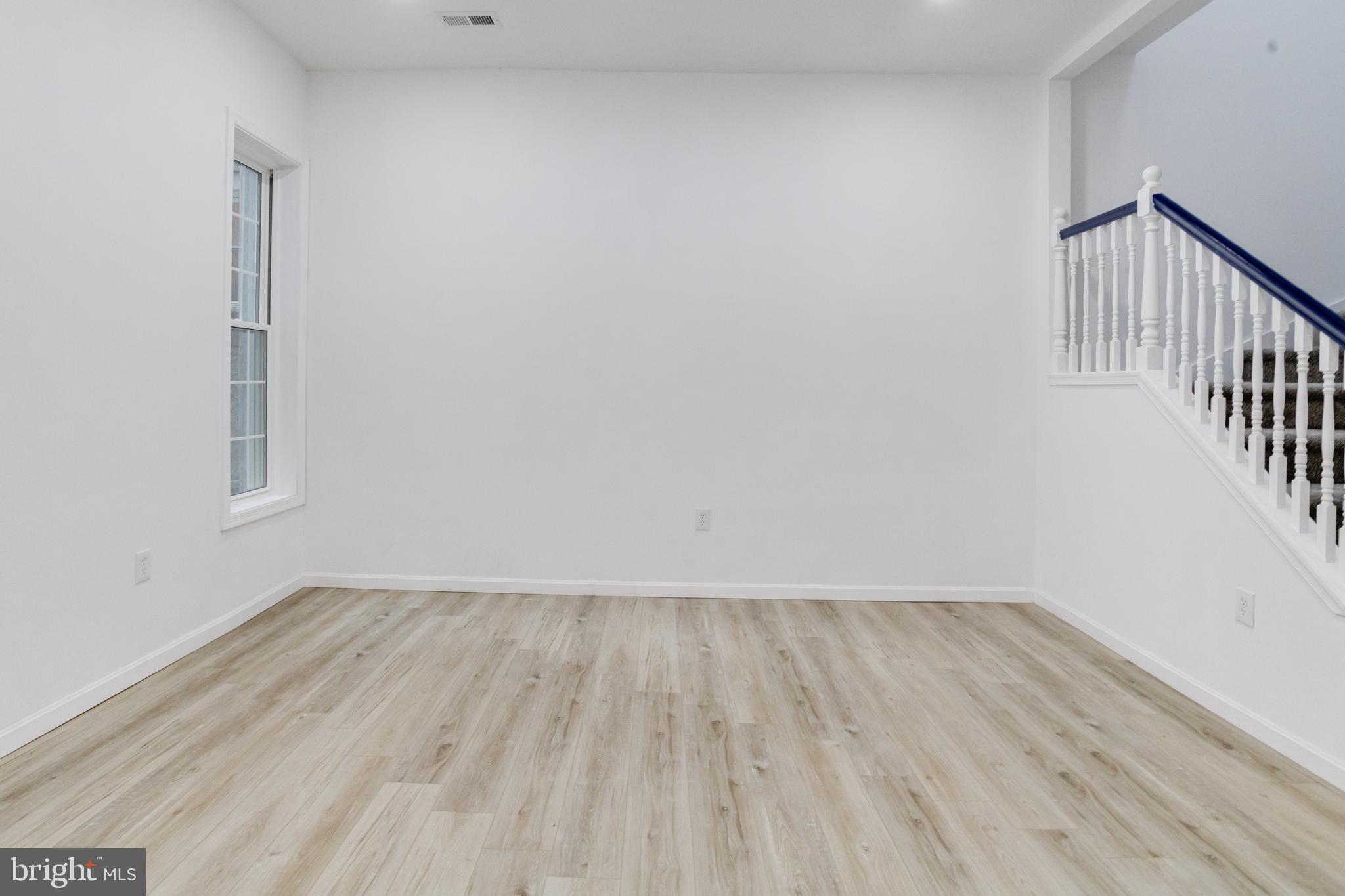 3015 Windsor Avenue Baltimore, MD 21216 - Photo 30 of 84 a view of an empty room with wooden floor and a window