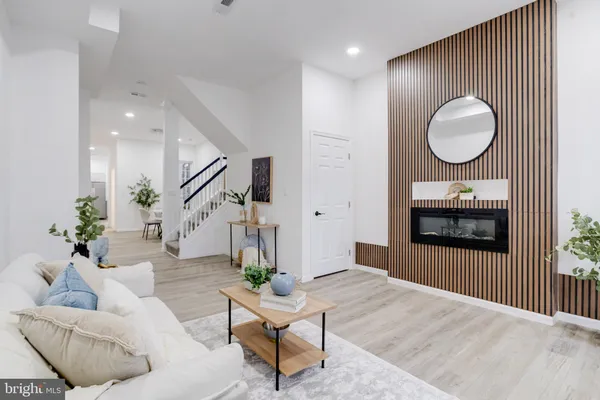 a living room with furniture and a mirror