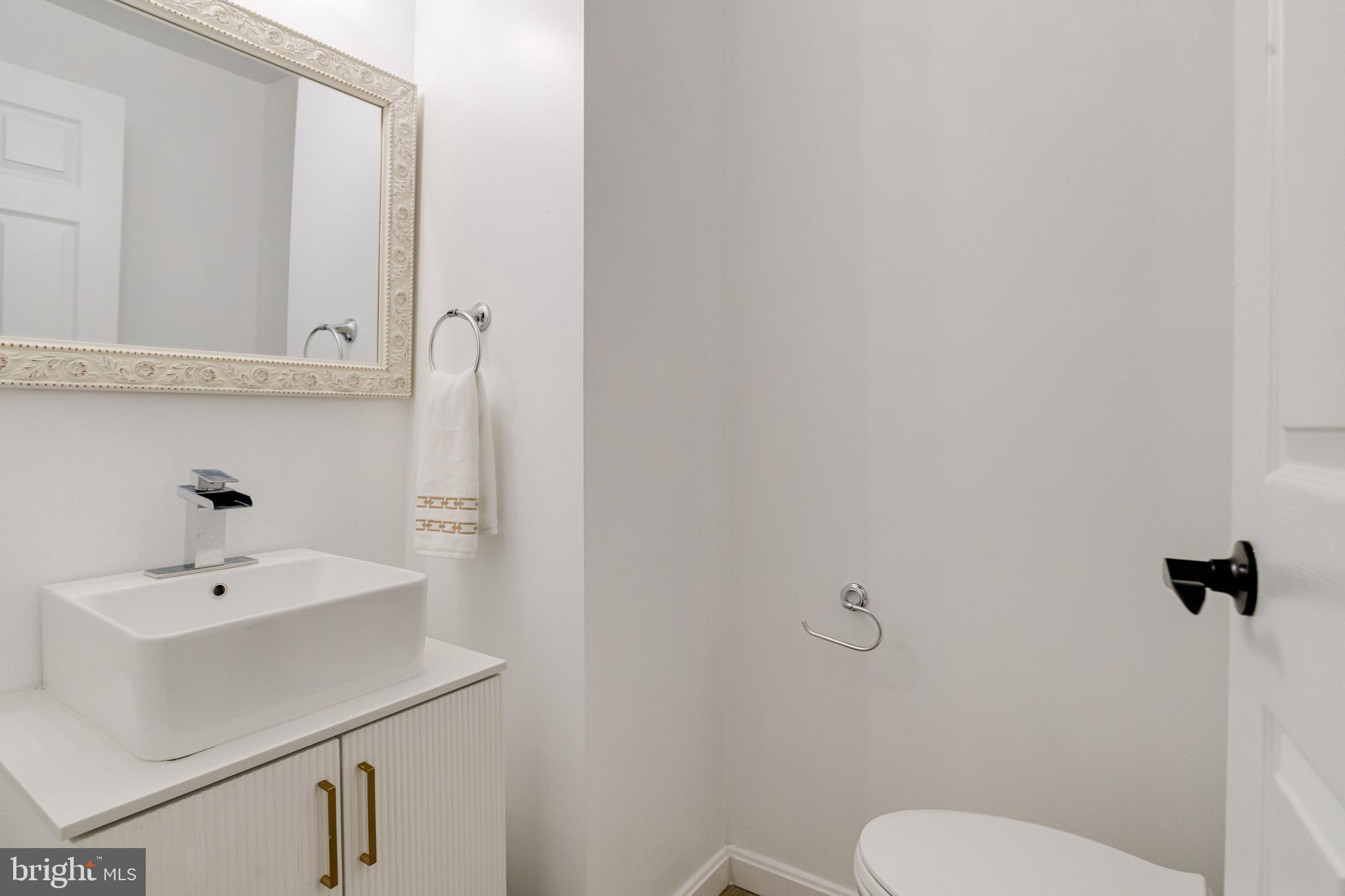 3015 Windsor Avenue Baltimore, MD 21216 - Photo 31 of 84 a bathroom with a sink a toilet and mirror